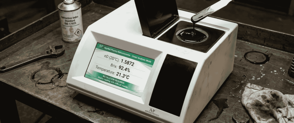 BK-R30 Digital Refractometer on a workbench, showing a sample in the tray with screen readings and lab tools
