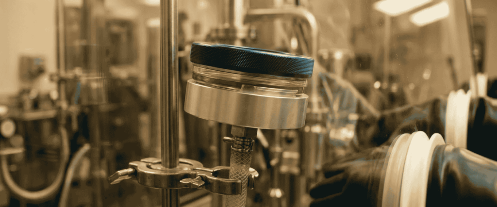 EU GMP Annex 1 pharmaceutical aseptic filling equipment in a sterile manufacturing facility with gloved operator