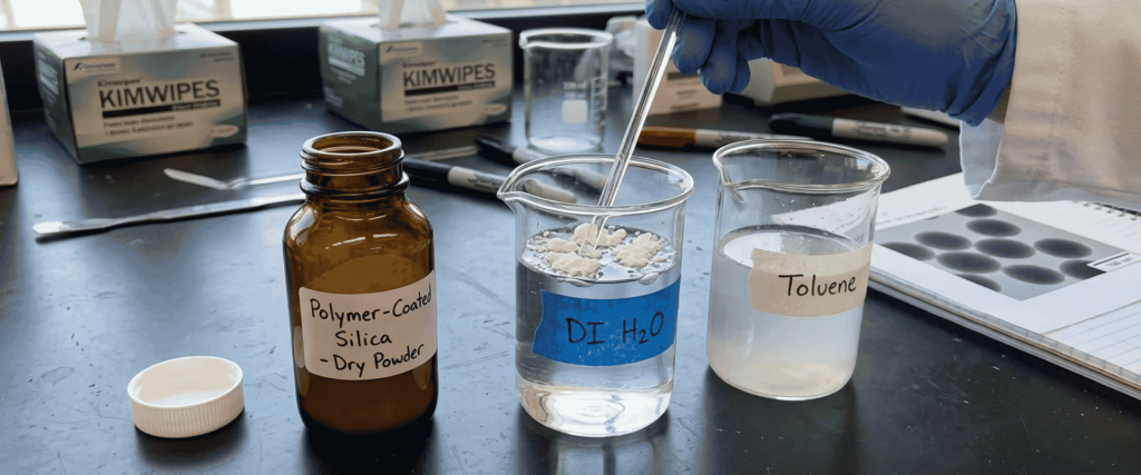 Ultrasonic Polymer-Coated silica powder tested in DI water and toluene beakers during laboratory preparation
