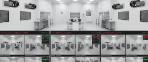 Cleanroom workers in white suits handling equipment under bright lights, with surveillance camera feeds and alerts displayed along bottom. 