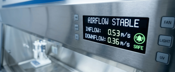 Biological Safety Cabinet display showing stable airflow, inflow 0.53 m/s and downflow 0.36 m/s, safe status indicator visible