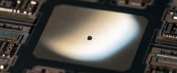 Particle on a microchip center, surrounded by circuit components, showing a close-up of advanced electronics technology