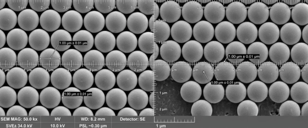 SEM micrograph of a close-packed array of uniform spherical microparticles with scale bars and annotations indicating 1.00 µm diameter