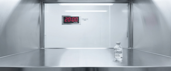 Sterile vial labeled STERILE WATER on stainless shelf under timer reading 20:00 in cleanroom cabinet USP 797

