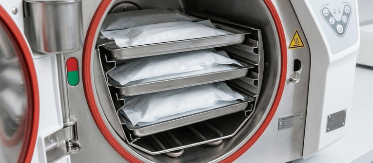 Autoclaves sterilizing wrapped medical trays inside a modern stainless steel hospital sterilization machine