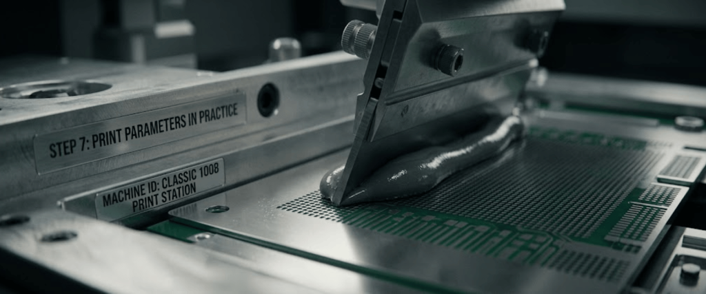 Automatic SMT Stencil Printer applying solder paste on a PCB stencil for precise surface mount electronics assembly
