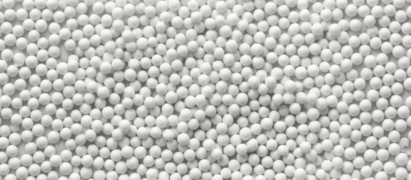 PSL Sphere Sizes white ceramic spheres arranged tightly in bulk, showing uniform ball sizes for industrial and decorative use
