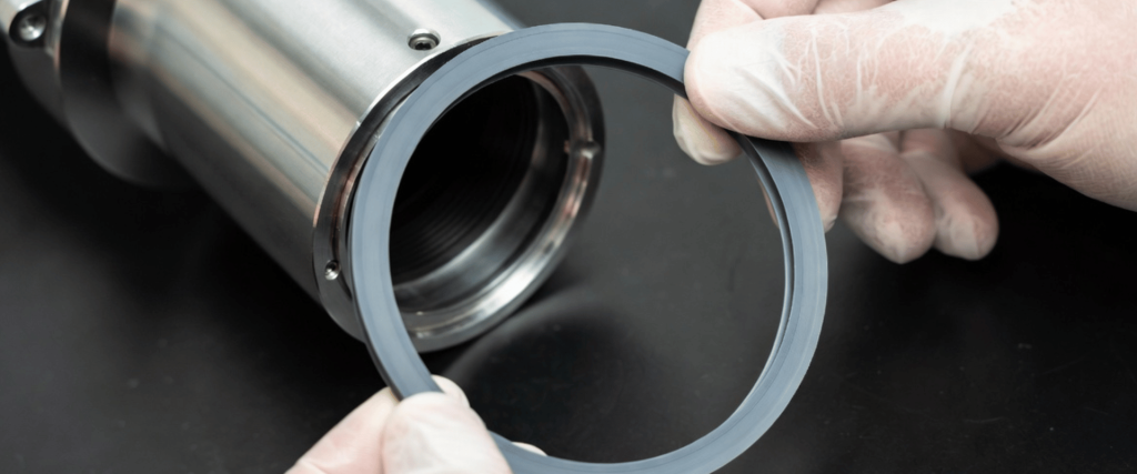 Elga UV stainless steel filter housing with replacement ring gasket held by gloved hands for maintenance