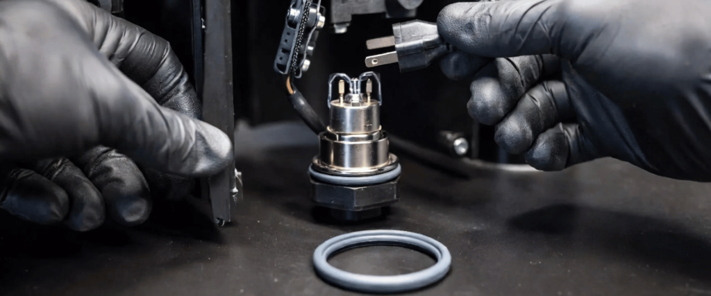 Elga UV technician wearing gloves installs a connector on a UV component, showing precise maintenance and assembly work