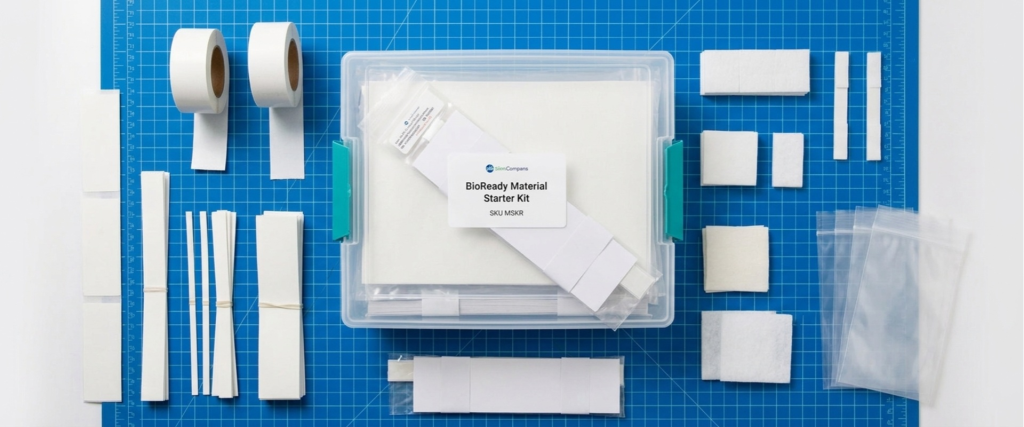 Lateral Flow bioready material starter kit with test strips, rolls, pouches, and sample components on a blue grid mat