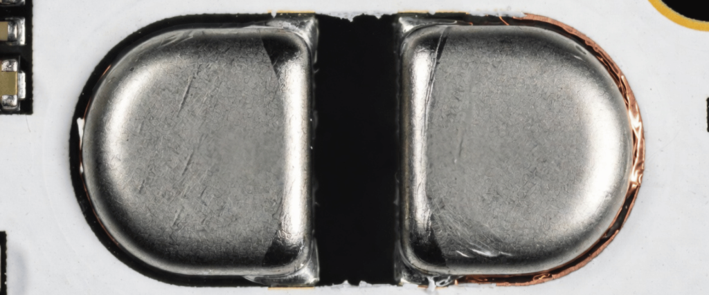 Solder Bridging on a circuit board, showing two metal pads connected by excess solder