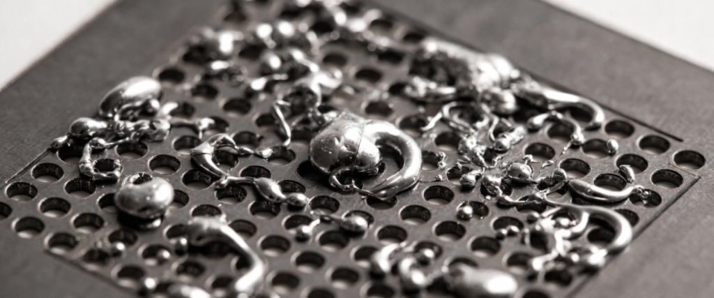 Solder Bridging on a perforated metal surface, showing excess solder blobs and connections across multiple circuit points