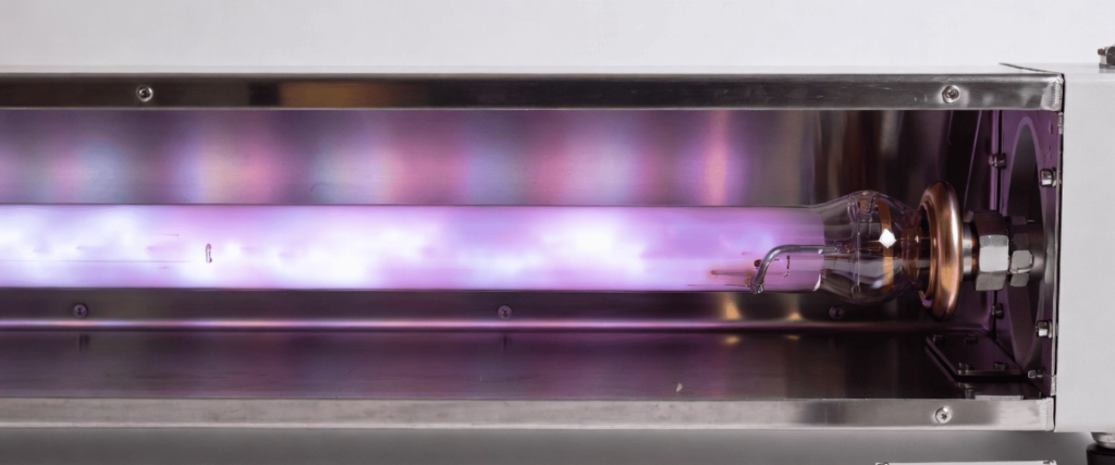 UV Electronic sterilization lamp inside a stainless steel housing, glowing purple with control unit attached