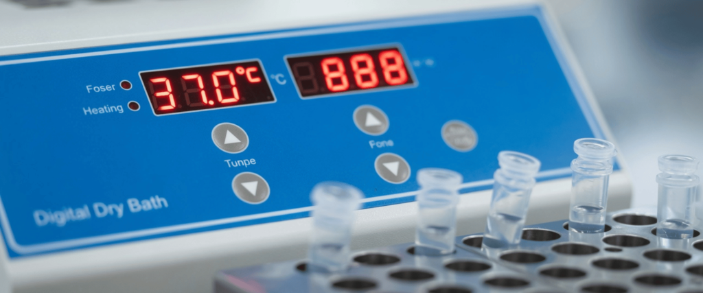 Volatile reagents in test tubes on a digital dry bath, showing temperature control for safe laboratory heating and analysis